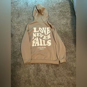 love never fails hoodie